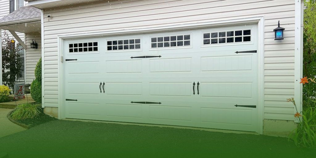 White carriage style garage door on a house